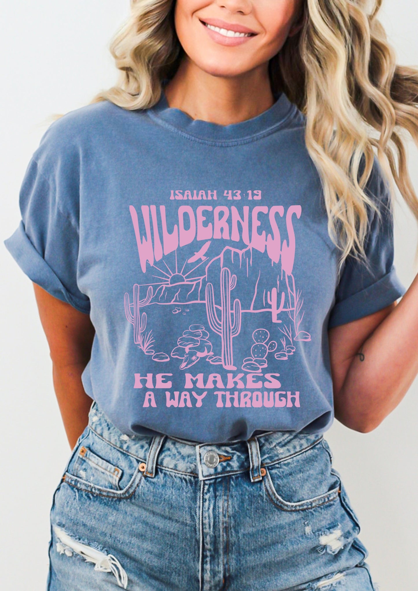 Pink lettering graphic western style shirt with inspirational quote “He makes a way through the Wilderness” 