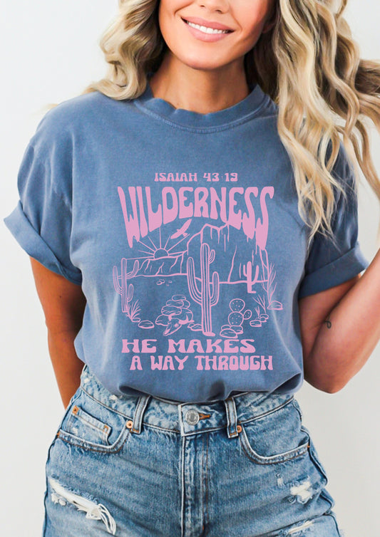 Pink lettering graphic western style shirt with inspirational quote “He makes a way through the Wilderness” 